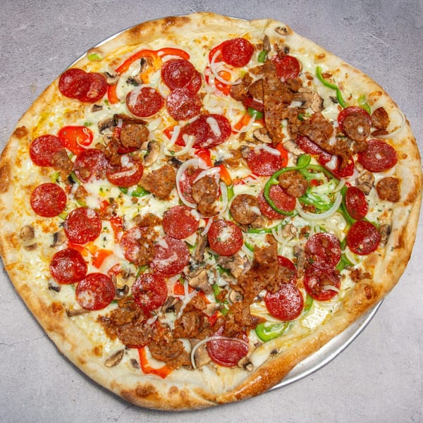 A large, round pizza with pepperoni, sausage, mushrooms, onions, and bell peppers.